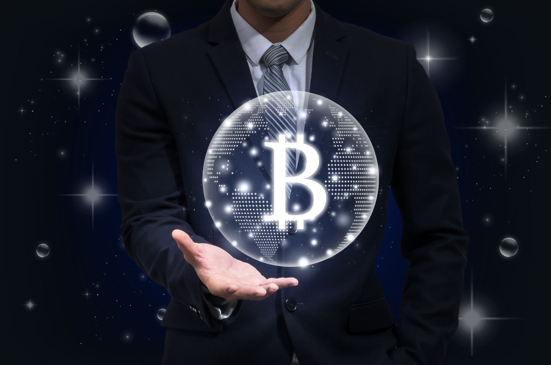 Businessman hand holding the bitcoins text financial technology or FINTECH connection over the dark background, Showing the cryptocurrency or digital money